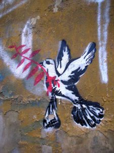 Paloma de la paz con una rama de olivo - grafitti - arte urbano